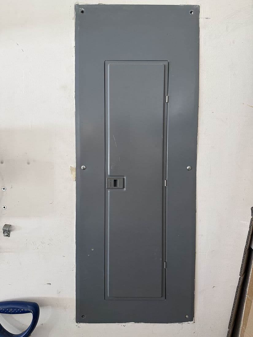 Domestic circuit breaker panel checked during an electrical certificate of compliance inspection.